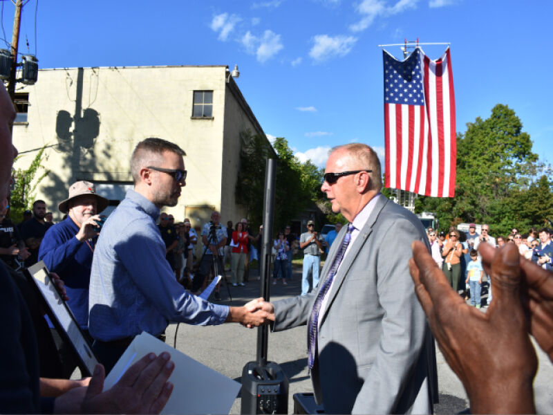 Evan Trent shakes hands.