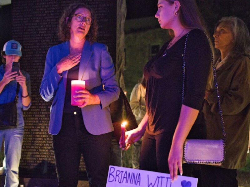 County Executive Jen Metzger with a demonstrator holding a Brianna Wittl sign.